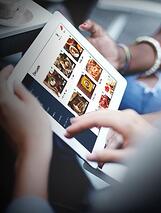 People viewing food menu with tablet