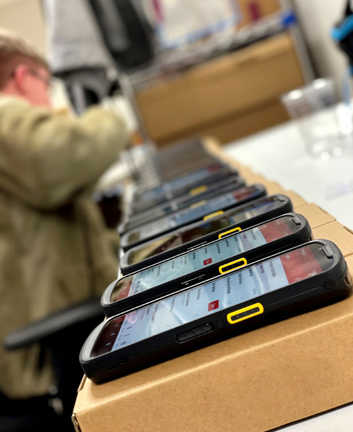 Multiple mobile devices being configured by Bailiwick employee