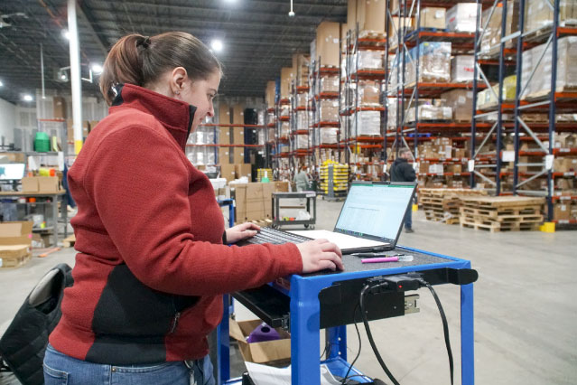 Bailiwick employee managing assets in a warehouse