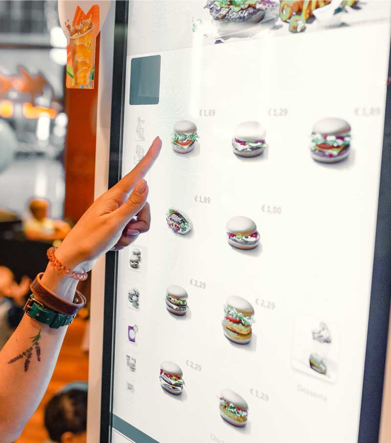 Woman using an indoor digital menu.