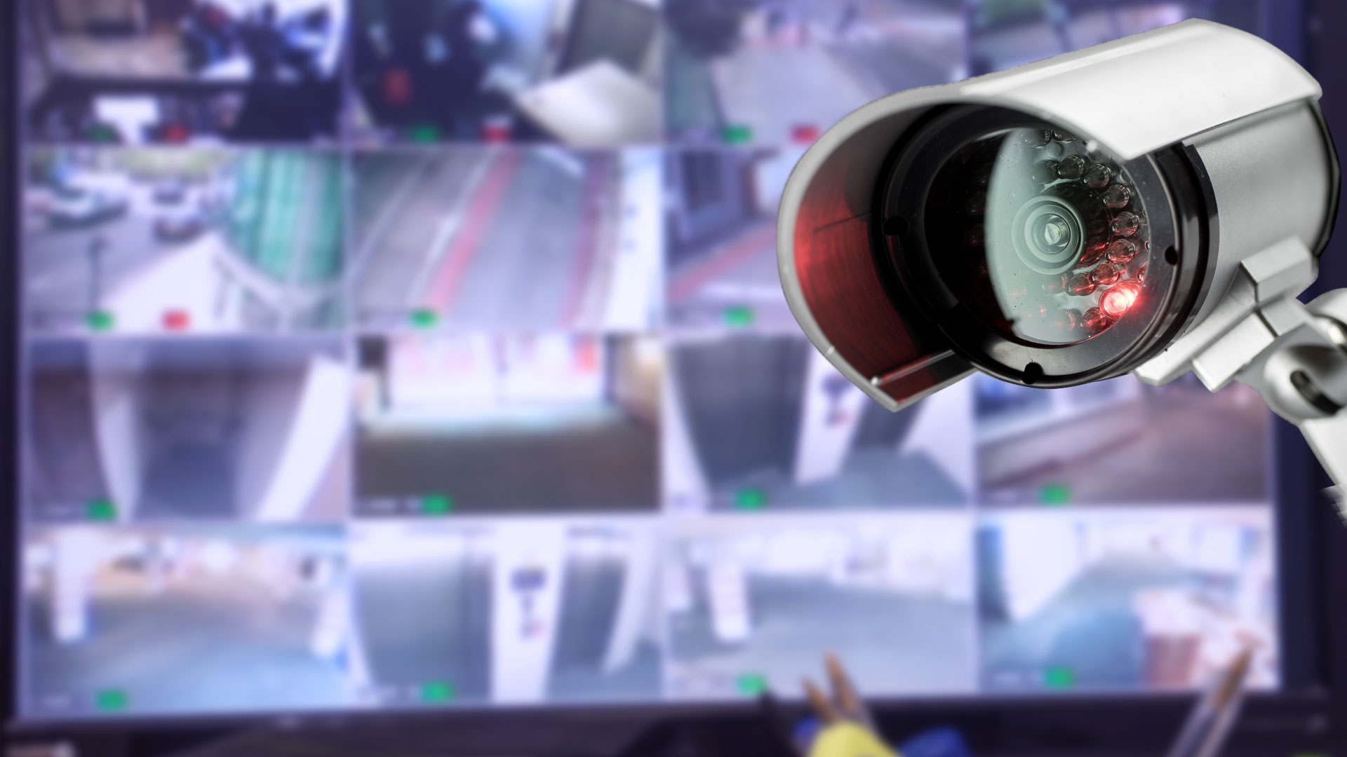 CCTV camera with images of security camera feeds in background.