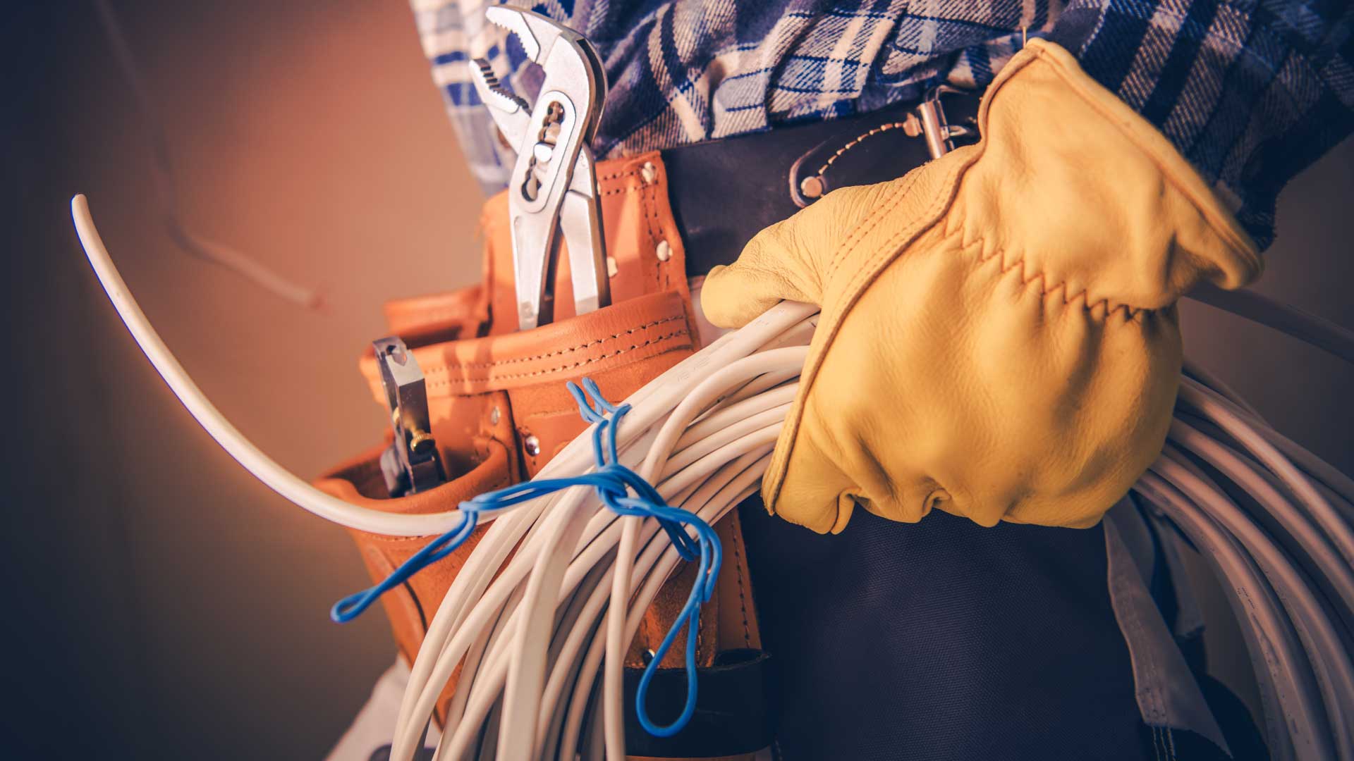 An electrician holding a bundle of cables.