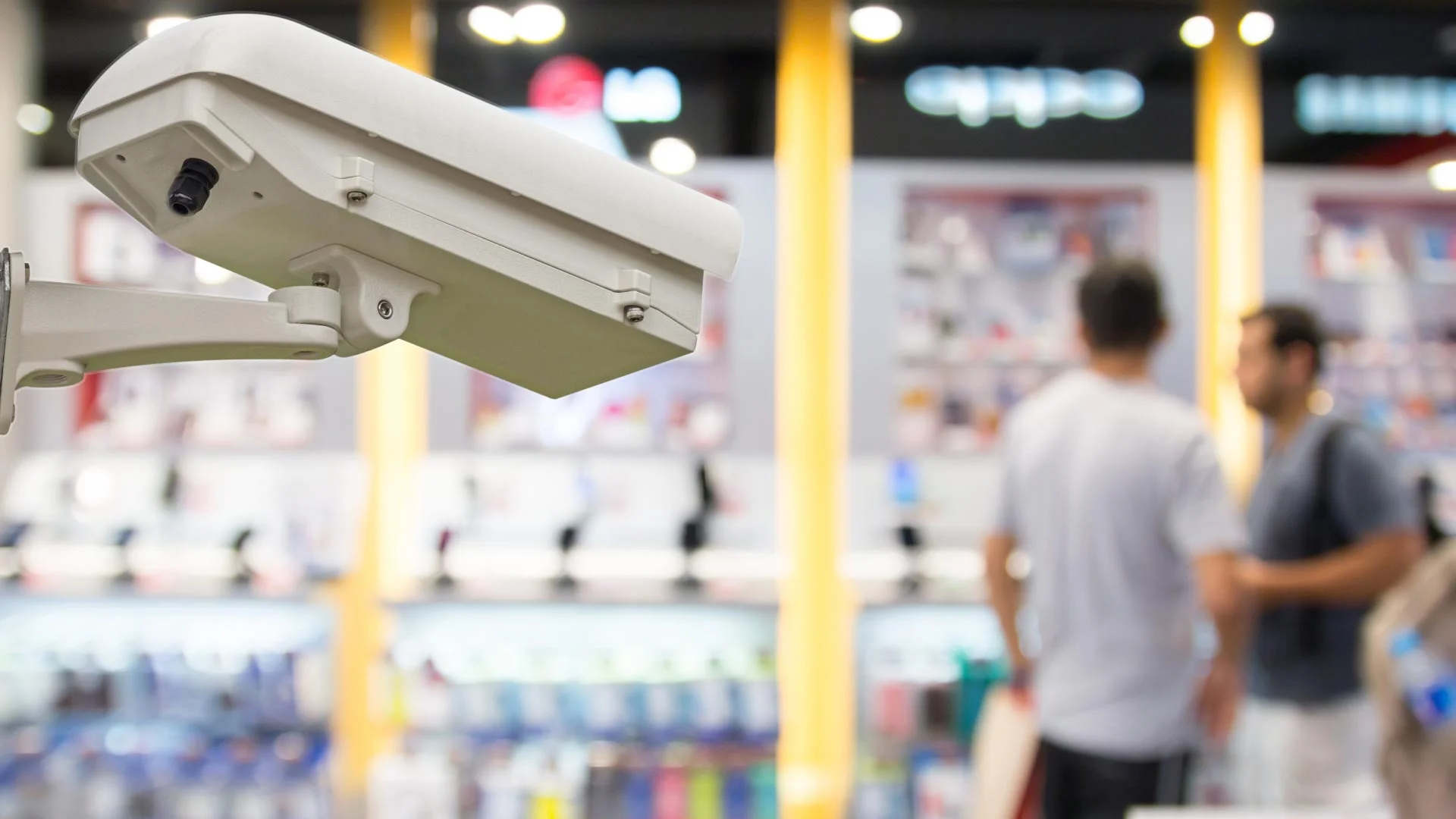 A security camera looking at two people in a retail environment.