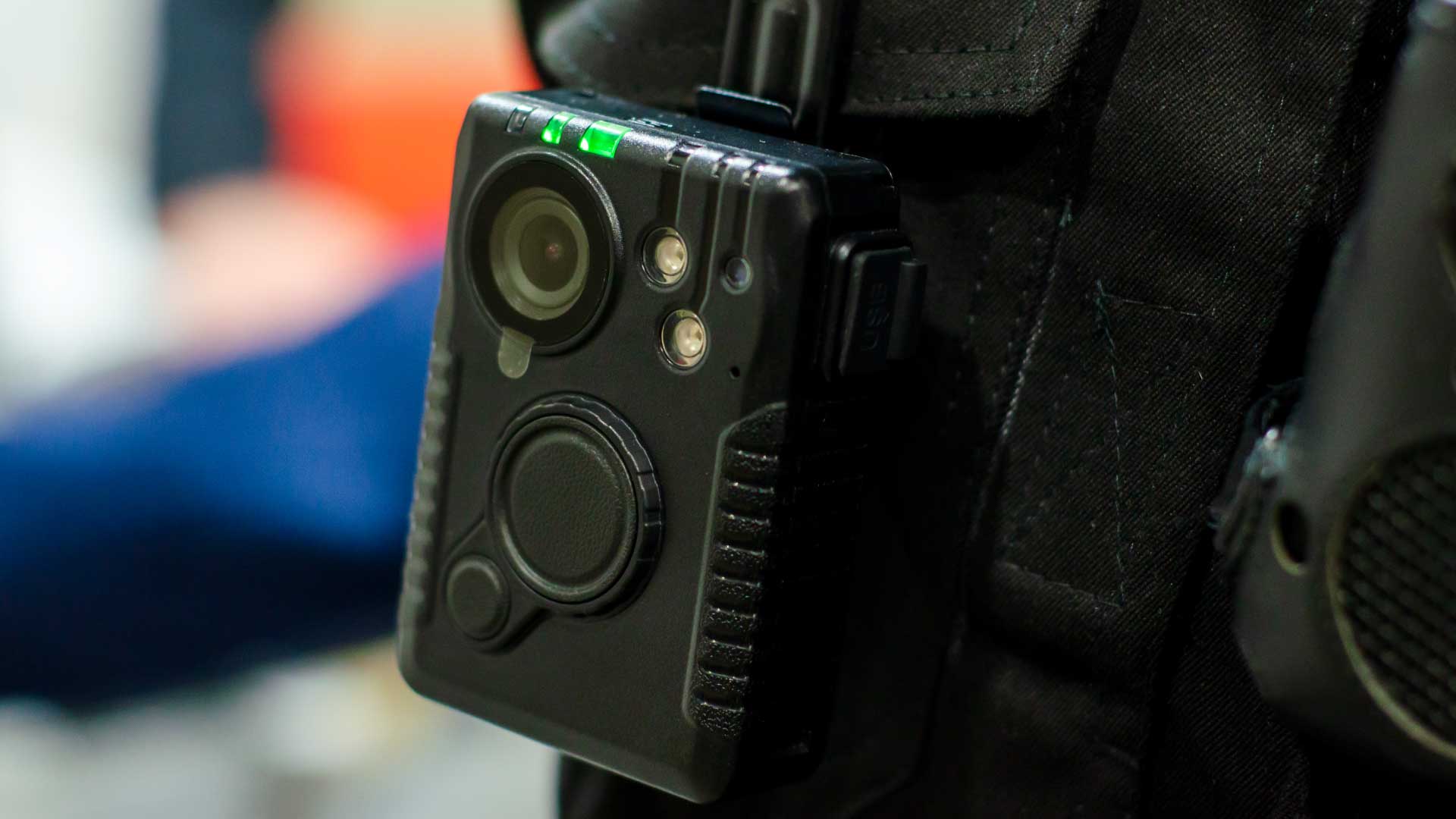 Closeup of a body camera attached to a vest.