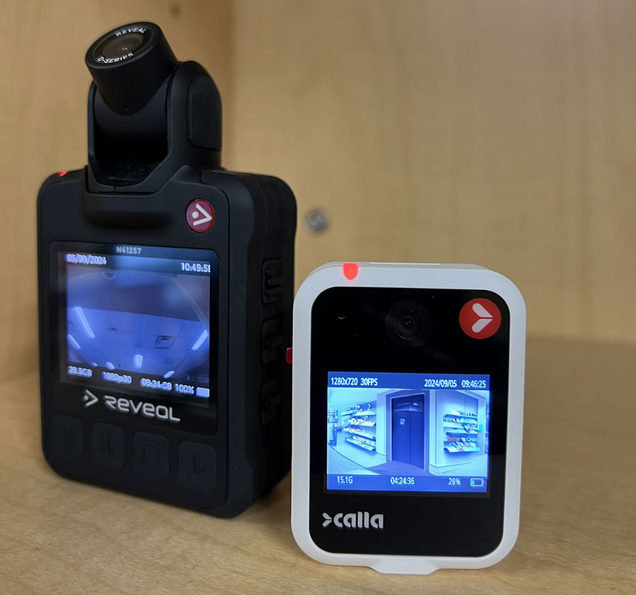 Two body cameras on a table.