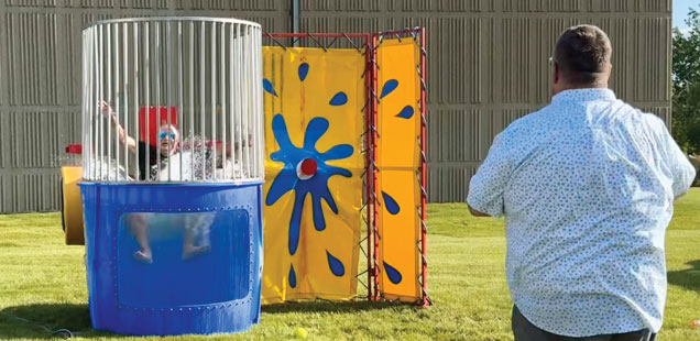 A game of dunk tank being played at a Bailiwick summer picnic